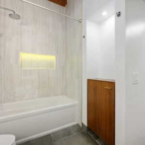 Bathroom with a view of the shower and cabinet