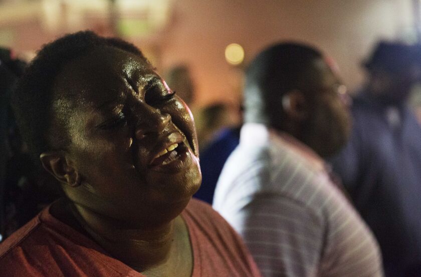 Lisa Doctor joins a prayer circle down the street from the Emanuel AME Church early Thursday, June 18, 2015 following a shooting Wednesday night in Charleston, S.C. | David Goldman / AP