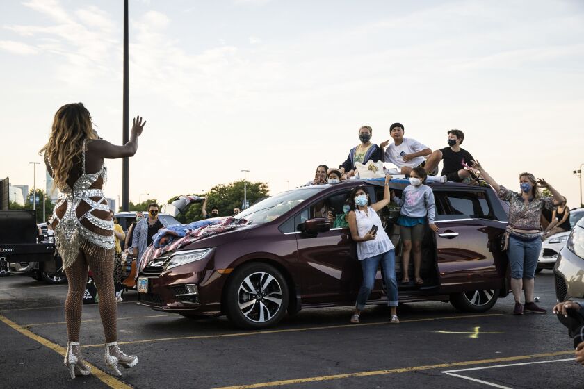 Asia O’Hara talks to the socially-distant crowd during Drive ‘N Drag presented by Voss Events at Soldier Field, Friday night, Aug. 7, 2020.