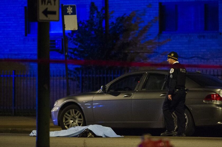 Police investigate the scene of a fatal hit-and-run, Tuesday morning in the 7900 block of South Cottage Grove. The victim was stuck on 79th and Cottage Grove and his body was dragged to 79th and Dobson. | Tyler LaRiviere/Sun-Times