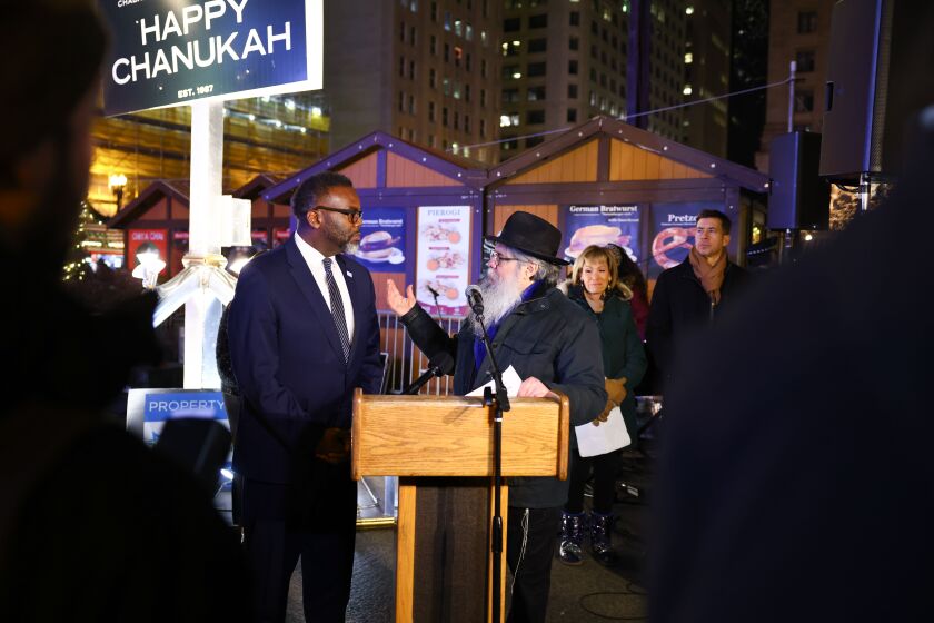 Mayor Brandon Johnson speaks to Rabbi Meir Chai Benhiyoun at the menorah-lighting ceremony in Daley Plaza. “The festival of lights reminds us that light triumphs over darkness, and unity will always prevail over division,” Johnson said.