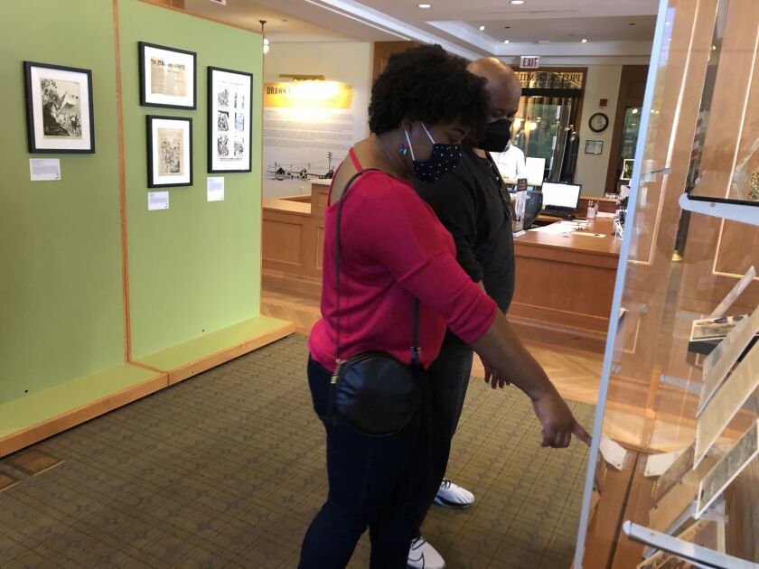 A couple examining museum exhibits.