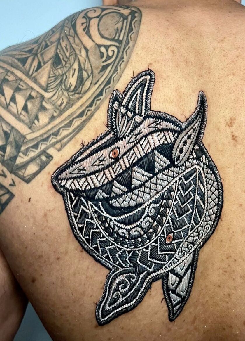 Saad Aziz’s patch tattoo is a Polynesian-style yin and yang formation of a shark and a whale, inspired by his time in Bali. 