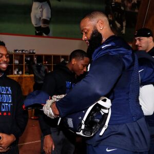 Bears defensive tackle Akiem Hicks signs a hat. | Provided by Chicago Bears
