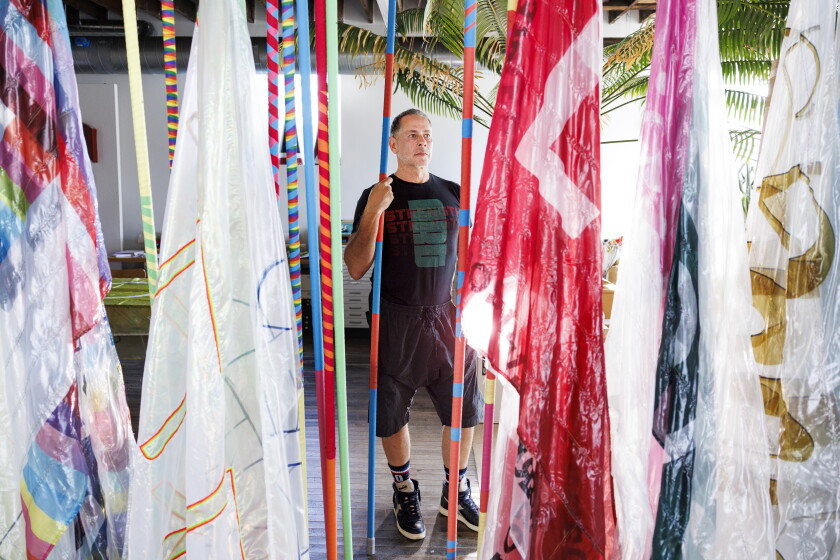 Artist Bob Faust at his studio in Irving Park with some of the flags for his work “Ways & Means,” Sept. 11, 2026.