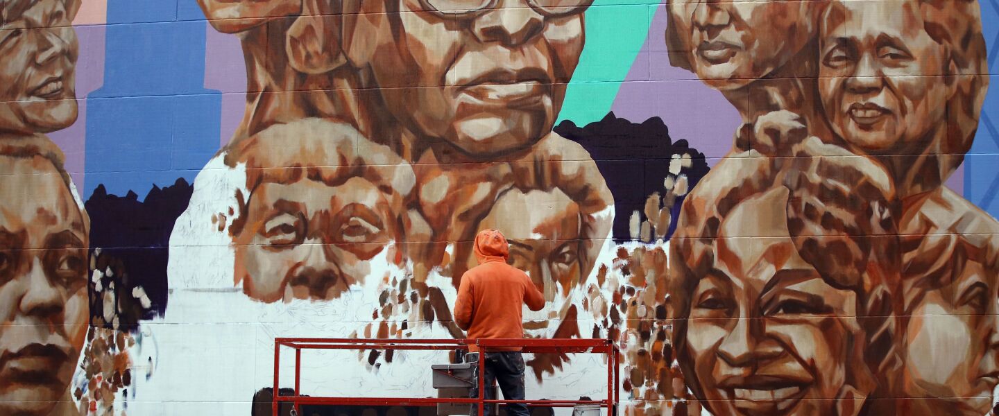 Jeff Zimmerman painting a mural by artist Kerry James Marshall at the Chicago Cultural Center in November 2017.