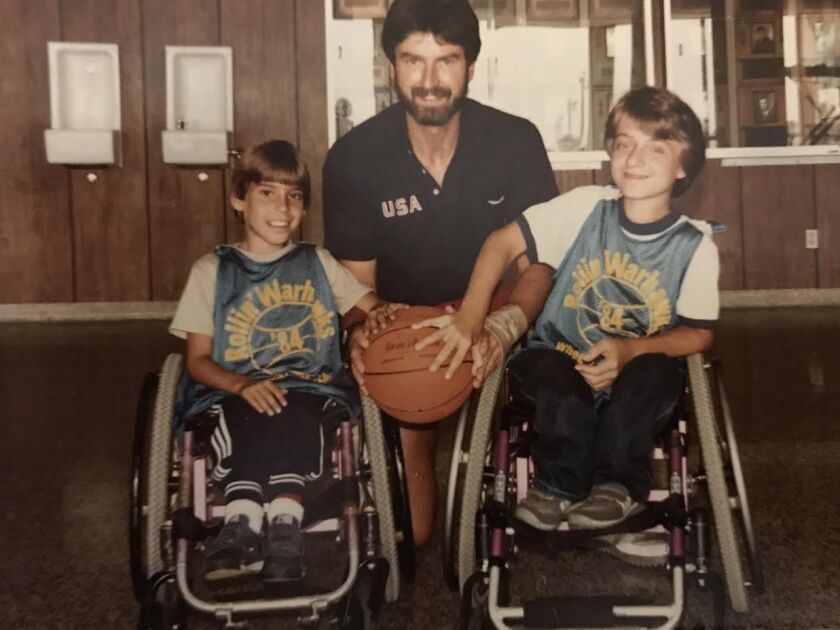 Coach Frank Burns with some of his students. He conducted wheelchair basketball tournaments throughout the United States as well as in Mexico, Canada, Japan, South Korea and Bahrain.
