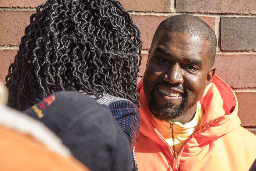 Chicago mayoral candidate Amara Enyia chats with Kanye West during a “pull-up” rally near East 63rd Street and South Cottage Grove Avenue, Tuesday afternoon, Oct. 23, 2018. | Ashlee Rezin/Sun-Times