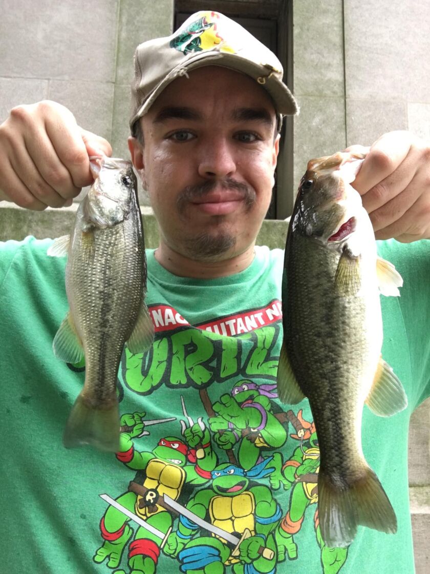 Jeffrey Williams with a couple largemouth bass caught from the Chicago River. Provided photo