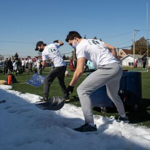 Students shovel snow to put in a wading pool for their version of the Polar Plunge at St. Patrick’s High School in the Belmont Central neighborhood, Saturday morning, March 6, 2021.