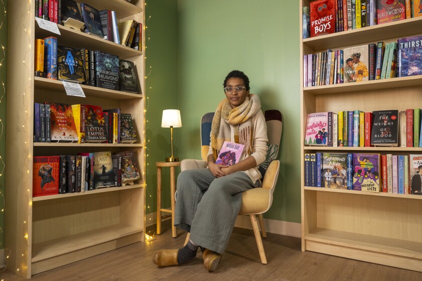 Courtney Bledsoe, owner of Call & Response Books, sits in her Hyde Park bookstore holding one of her favorite books, βWash Day Diariesβ by Jamila Rowser and Robyn Smith, Wednesday, Jan. 29, 2025. | Tyler Pasciak LaRiviere/Sun-Times