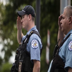 Officers salute outside the Cook County medical examiner’s office on the afternoon of Tuesday, July 28, 2020 as an ambulance passes containing the body of Deputy Chief Dion Boyd, who was found dead in his office that morning of an apparent suicide.