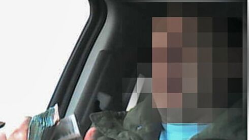 A Cook County Board of Review employee allegedly counts thousands of dollars in bribe money for lowering property assessments, according to a photograph attached to a federal affidavit obtained by the Sun-Times. The Sun-Times is not naming the employee and has pixelated his face; he is not charged.