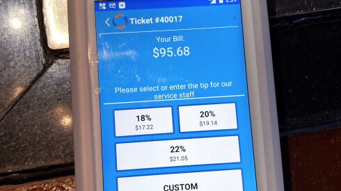 A tipping option is displayed on a card reader at a restaurant in Schaumburg. Tipping fatigue, it seems, is swarming America as more businesses adopt digital payment methods that automatically prompts customers to leave a gratuity.
