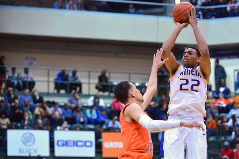 Simeon’s Jabari Parker shoots a jumper over Young’s Paul White.