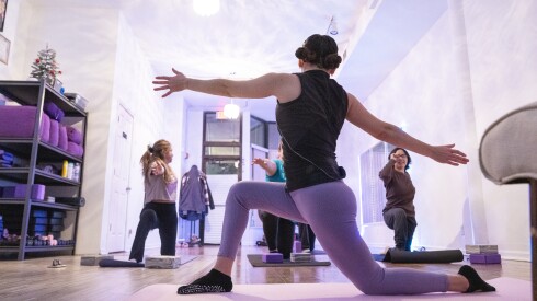 Cristel Paiz owner of Cristel Yoga, located in suburban Berwyn, leads a small group of women through a guided yoga exercise on November 26.