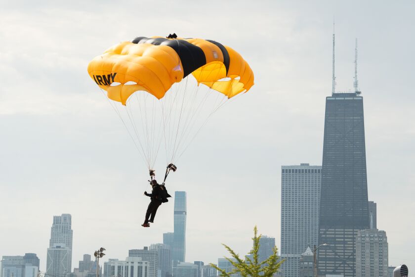 A member of the U.S. Army Golden Knights glides with a parachute after jumping from a plane during the Air and Water Show at North Avenue Beach, Saturday, Aug. 19.