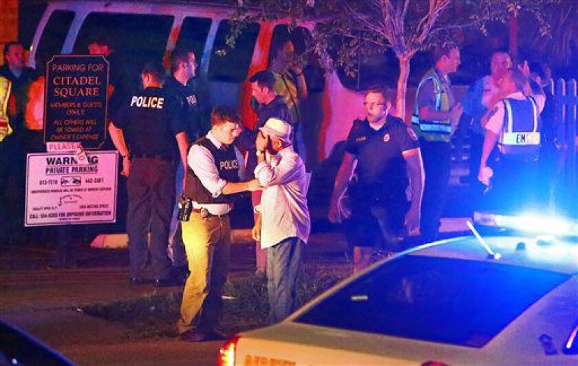 Police talk to a man outside the Emanuel AME Church following a shooting Wednesday. | Wade Spees/The Post And Courier via AP