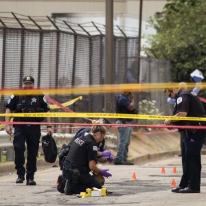 Chicago Police investigate at the 25th District station, 5555 W. Grand Ave., on the Northwest Side, after multiple officers were shot outside the station, Thursday morning, July 30, 2020. The suspect was also shot multiple times in the incident.