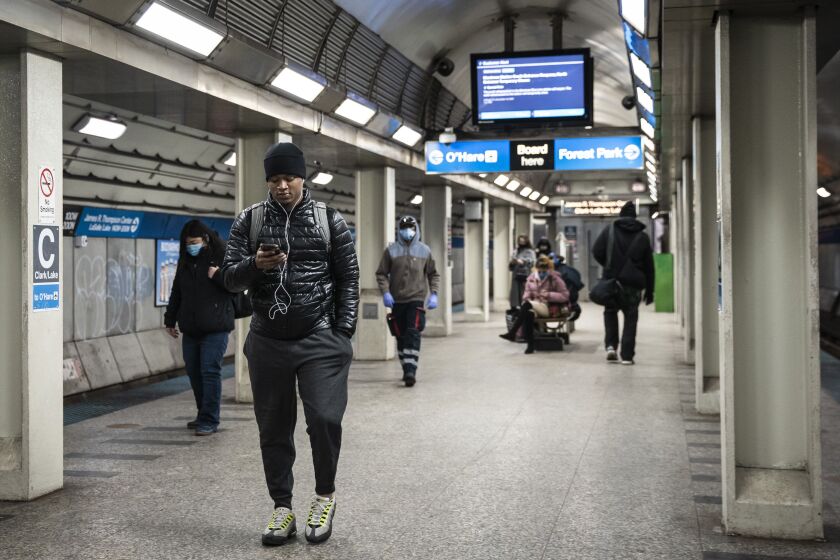 People wait to board a Blue Line train at the CTA’s Clark/Lake station in the Loop, Wednesday afternoon, Feb. 3, 2021.