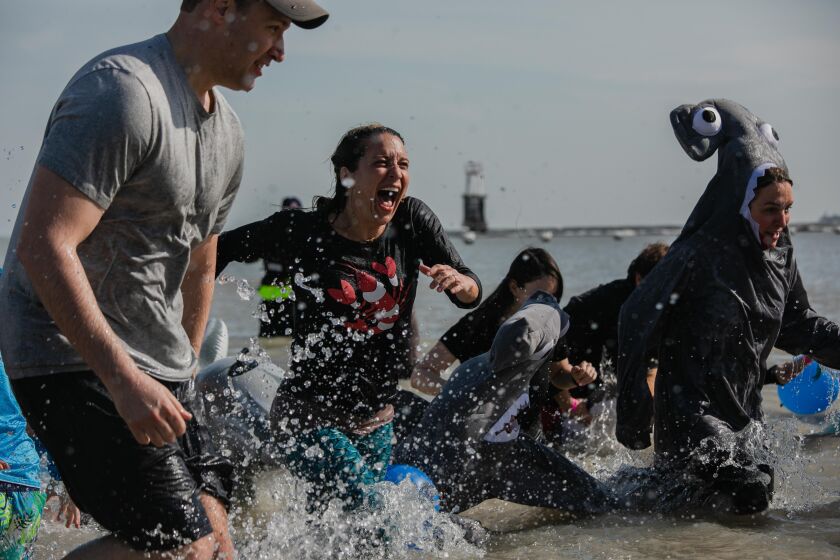 Participants of the 20th Annual Chicago Polar Plunge run to the shore after taking a dip in 35 degree water at North Avenue Beach, Sunday morning, March 1, 2020. Around 5,000 people attended Special Olympics Chicago’s largest fundraising event.