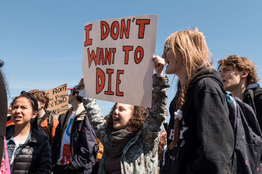 Jolie Davidson, a senior at Francis W. Parker school, walked out of class Friday, April 20, along with hundreds of other students from around Chicago to protest gun violence in a rally at Grant Park. | Erin Brown/Sun-Times