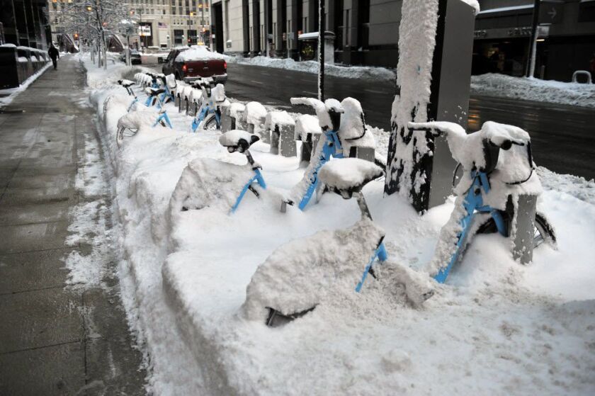 Divvy bikes sit covered in snow near Franklin and Lake. | Al Podgorski / Sun-Times Media