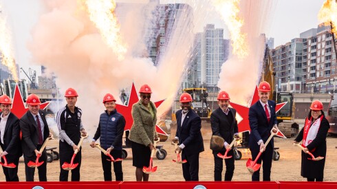 Chicago Fire leadership, development partners and city officials, including Ald. Pat Dowell (3rd) and Mayor Brandon Johnson (center), hold ceremonial shovels during the Chicago Fire FC's stadium groundbreaking at The 78 in South Loop.