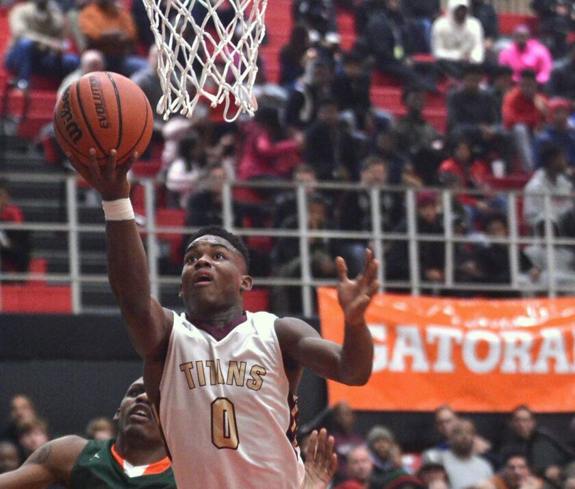 Uplift’s Markese Jacobs (0) drives to the basket against Morgan Park in the Proviso West Holiday Tournament. Worsom Robinson/ For the Sun-Times.