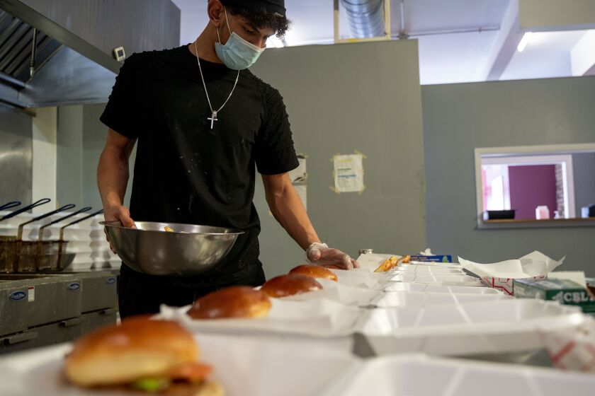 Ariel Burns, 21, an employee of Urban Grill Chicago, 1132 W. Wilson Ave., prepares for catering, Wednesday afternoon, March 3, 2021. | Mengshin Lin/Sun-Times