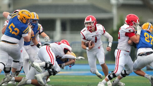 Hinsdale Central’s Riley Contreras (1) carries the ball against Lyons.