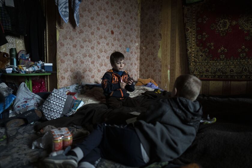 Vlad, 6, is playing cards with a friend.