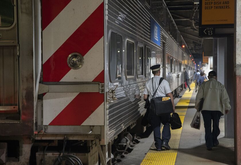 Commuters board an outbound Metra train at Union Station in Chicago, Tuesday, Sept. 13.