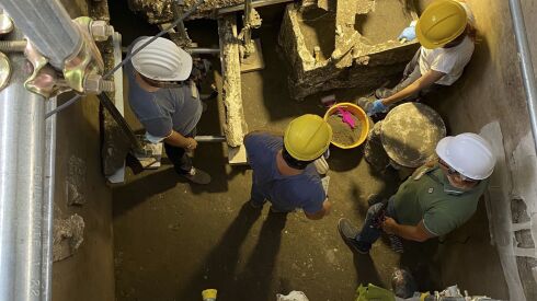 Archeologists work on the site of a new discovery in the ruins of the ancient city of Pompeii. 