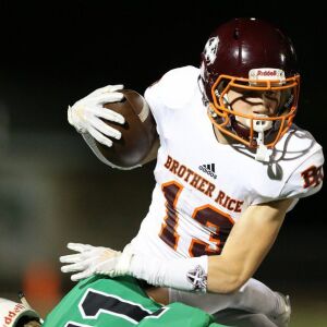 Brother Rice’s Dylan Summers (13) shakes off a tackler. Allen Cunningham/For the Sun-Times.