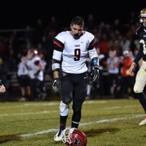 Yorkville’s Cole Ferguson (9) walks over to pick up his helmet. Worsom Robinson/For the Sun-Times.