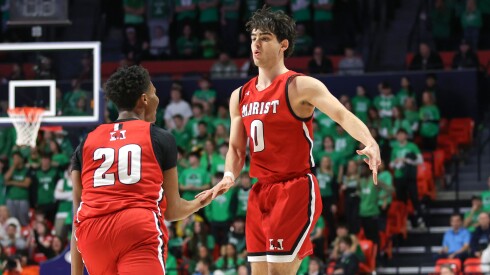 Marist's Adoni Vassilakis (0) celebrates with Kendall Meyers (20) during the 4A semifinal game against York at State Farm Center.