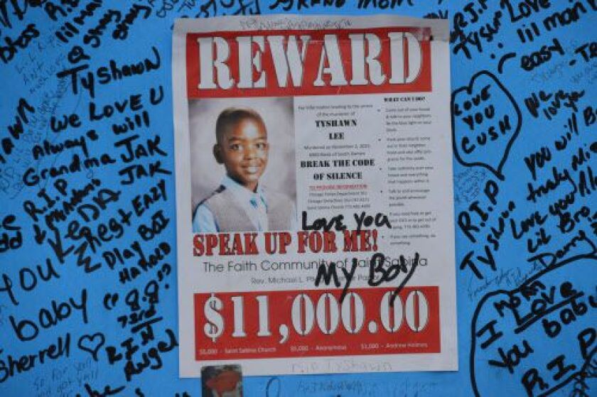 A poster at a memorial for Tyshawn Lee posted near where he was killed in 2015. Two men charged with the 9-year-old’s murder are on trial.