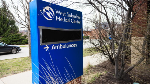 Black plastic covers the emergency room signs at West Suburban Medical Center in Oak Park showing that it is closed.