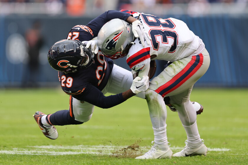 The Bears' Tyrique Stevenson tackles Rhamondre Stevenson of the New England Patriots during the fourth quarter at Soldier Field on Nov. 10, 2024.