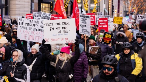Protesters march along North Michigan Avenue in Streeterville on Saturday to denounce the arrest of Venezuela’s President Maduro and the killings of Renee Nicole Good and Silverio Villegas González by federal immigration agents.