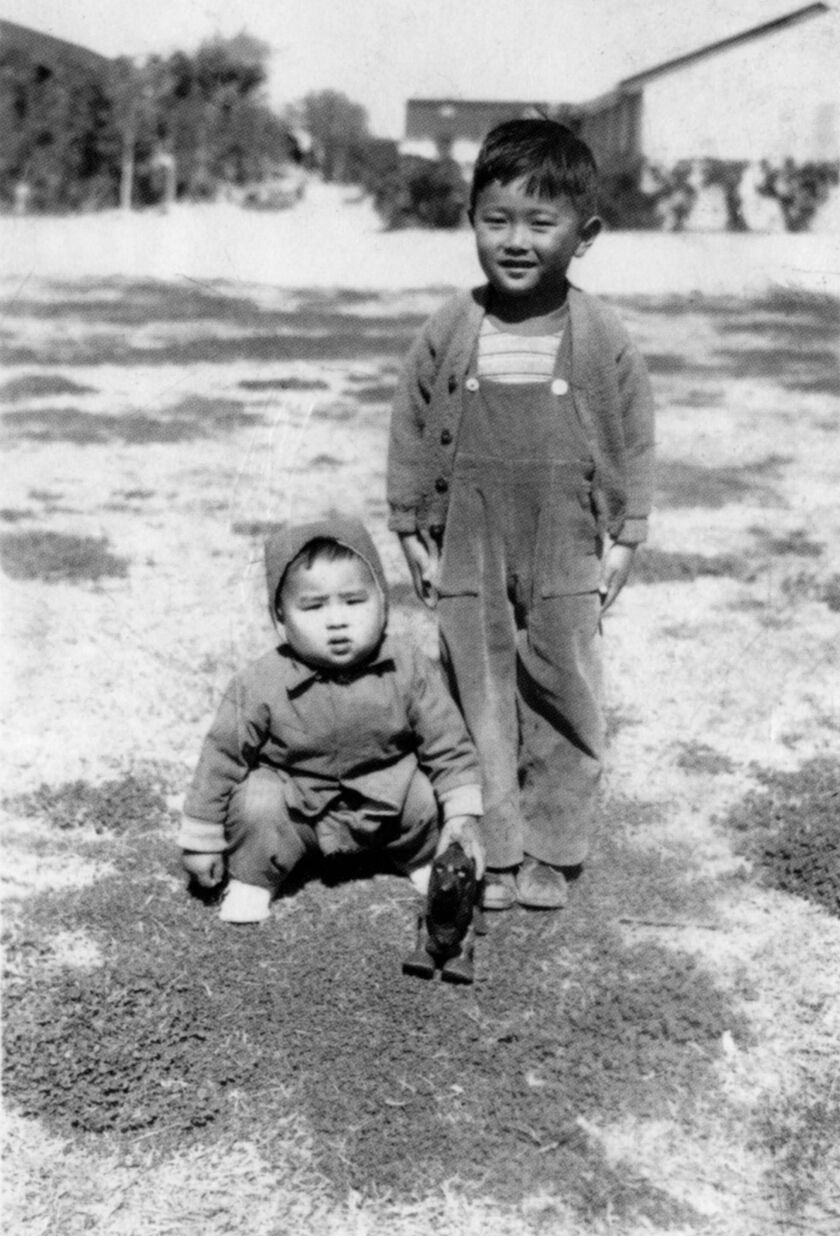 Sun-Times editor Frank Sugano (seated, with toy) and his brother Bill at the Gila River internment camp in Arizona where Frank was born. He became a respected Sun-Times editor. | Photo from 2006 book “Who We Were,” by Michael Williams, Richard Cahan and N
