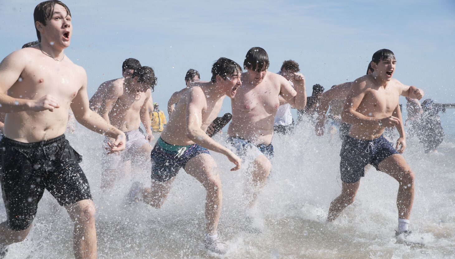 NextImg:Polar plungers brave chilly water on sunny day at North Avenue Beach