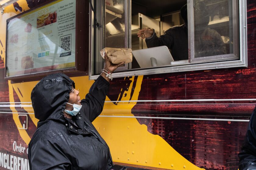 Cynthia McKee receives her order from Uncle Remus on the last day of the Chicago Food Truck Festival at Daley Plaza in the Loop, Friday, Oct. 7, 2022.
