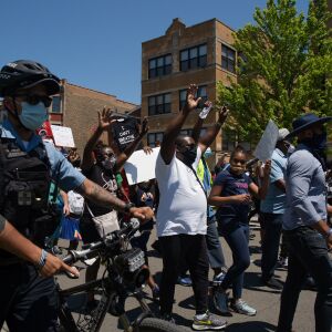 Protesters march down South Independence Boulevard in North Lawndale during the West Side interfaith peace march to demand police reform and equal opportunities for Black Americans on June 12, 2020. Protesters stopped at sites that Dr. Martin Luther King Jr. visited.