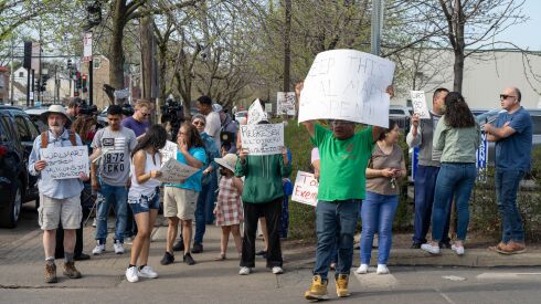Members of the Little Village Community Council and other residents protest outside Walmart Neighborhood Market in Little Village over the closure of four Walmarts in Chicago in April.