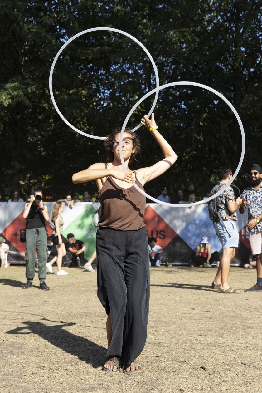 A festival-goer dances with hoops at Pitchfork Music Festival, Friday, Sept. 10, 2021.