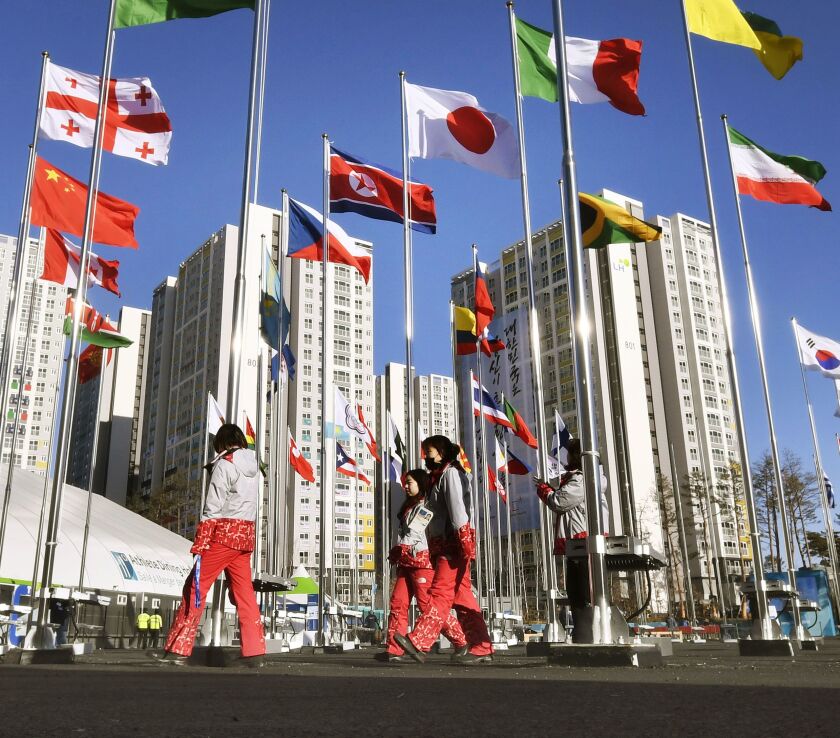 Flags of participating countries flutter in the wind at the Olympic village in Gangnueng, South Korea, on Thursday. | AP photo