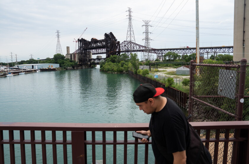A pedestrian crosses the East 95th Street Bridge, which overlooks the Calumet River, in South Deering on Wednesday.