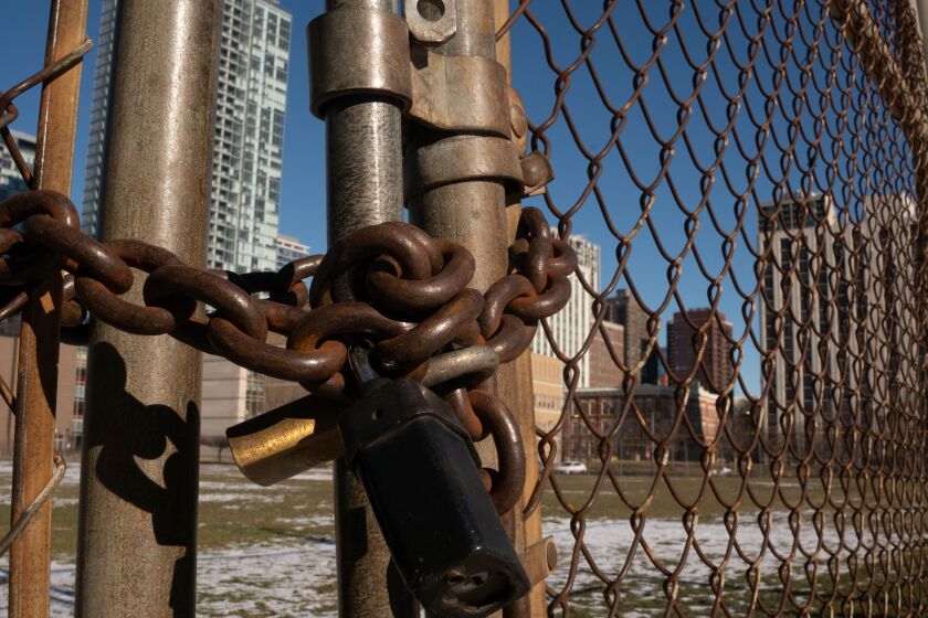 A locked gate protects land in the 300 block of West Oak Street which JDL Development intends to buy from the Moody Bible Institute for development.